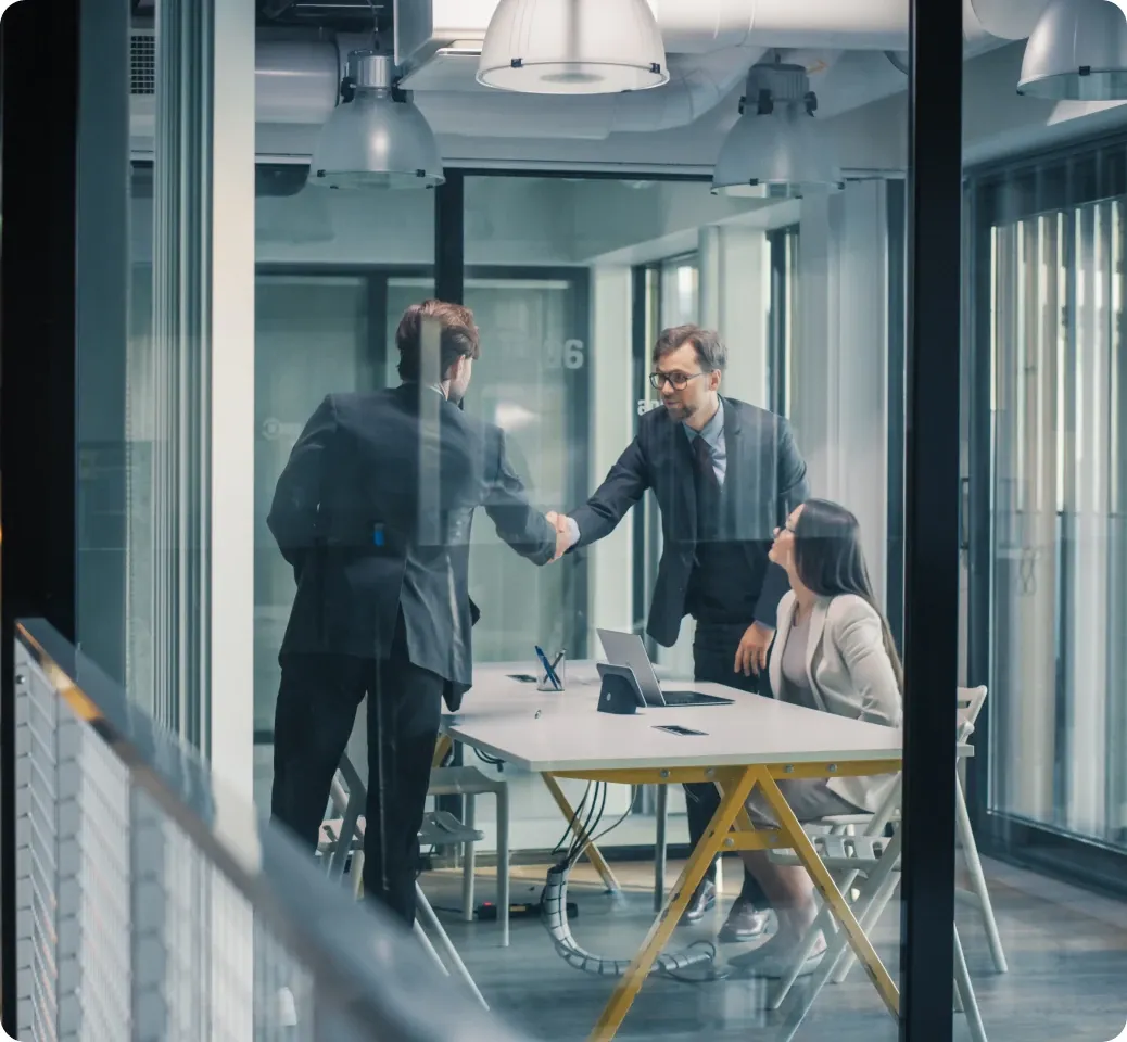 A recruiter interviewing a candidate across a table in a bright office