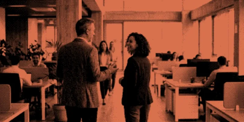 A new employee being welcomed through an open-plan workspace