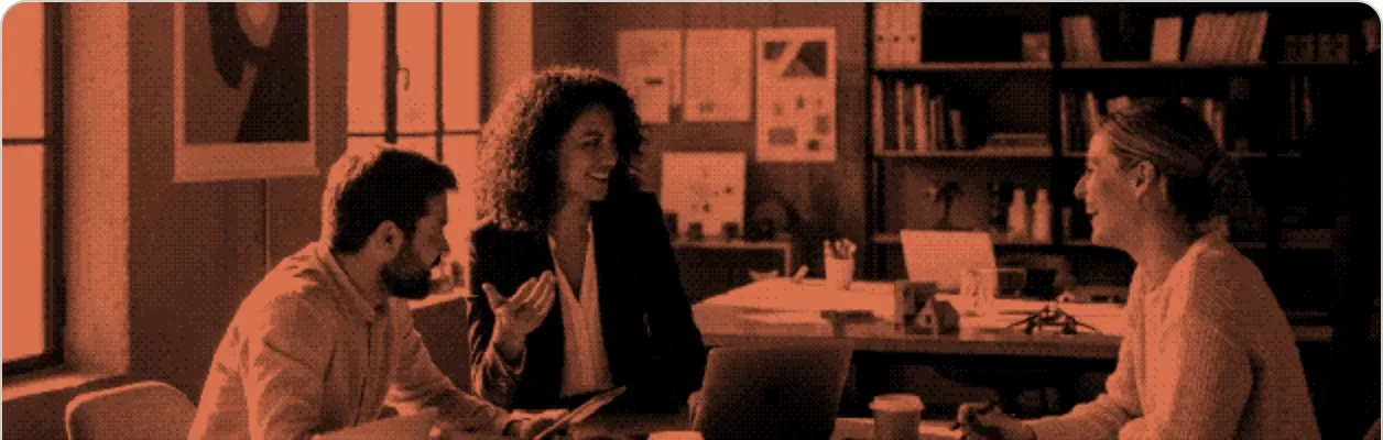 A hiring manager briefing two colleagues across a meeting table